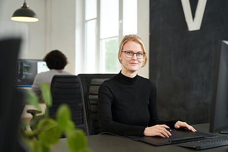 Porträt einer Mitarbeiterin von visuellverstehen in den modernen Büroräumen der Digitalagentur.